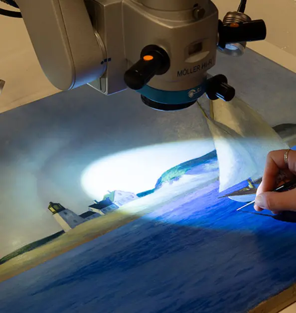 A microscope light illuminates a section of a painting.
