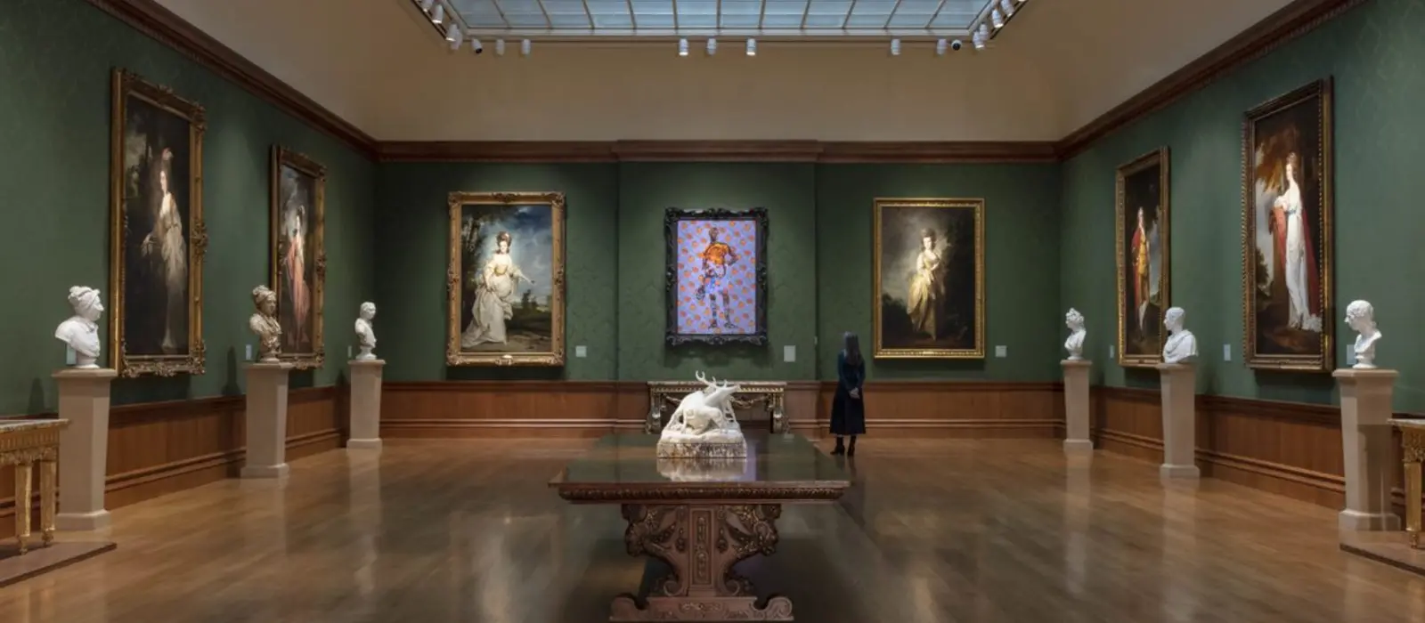 woman in gallery looking at paintings