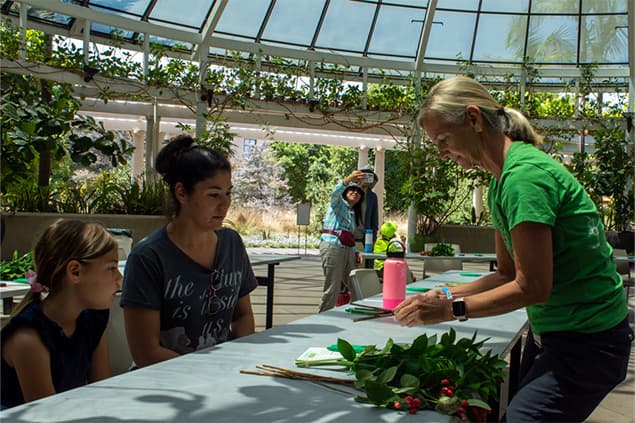 Mother and daughter learn flower arranging techniques at the Flower Arranging Bring a Buddy class.