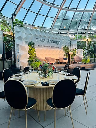 Round event table setup under glass dome.