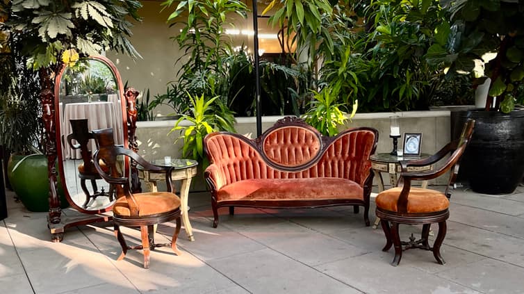 Victorian-themed couch and chairs set up for guests.