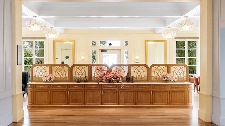 A server's side table leads to an egg-cream painted tea room interior.