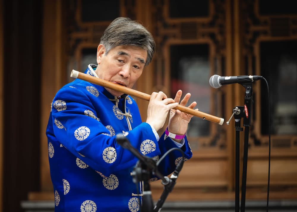 A person plays an wind instrument.