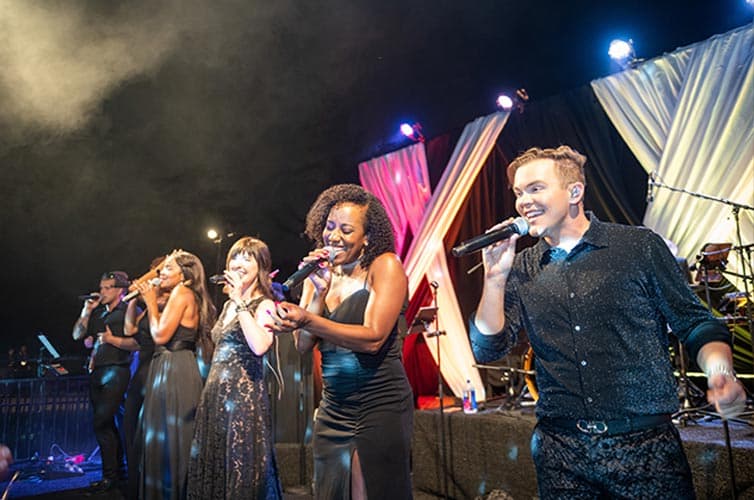 Singers on an outdoor stage.