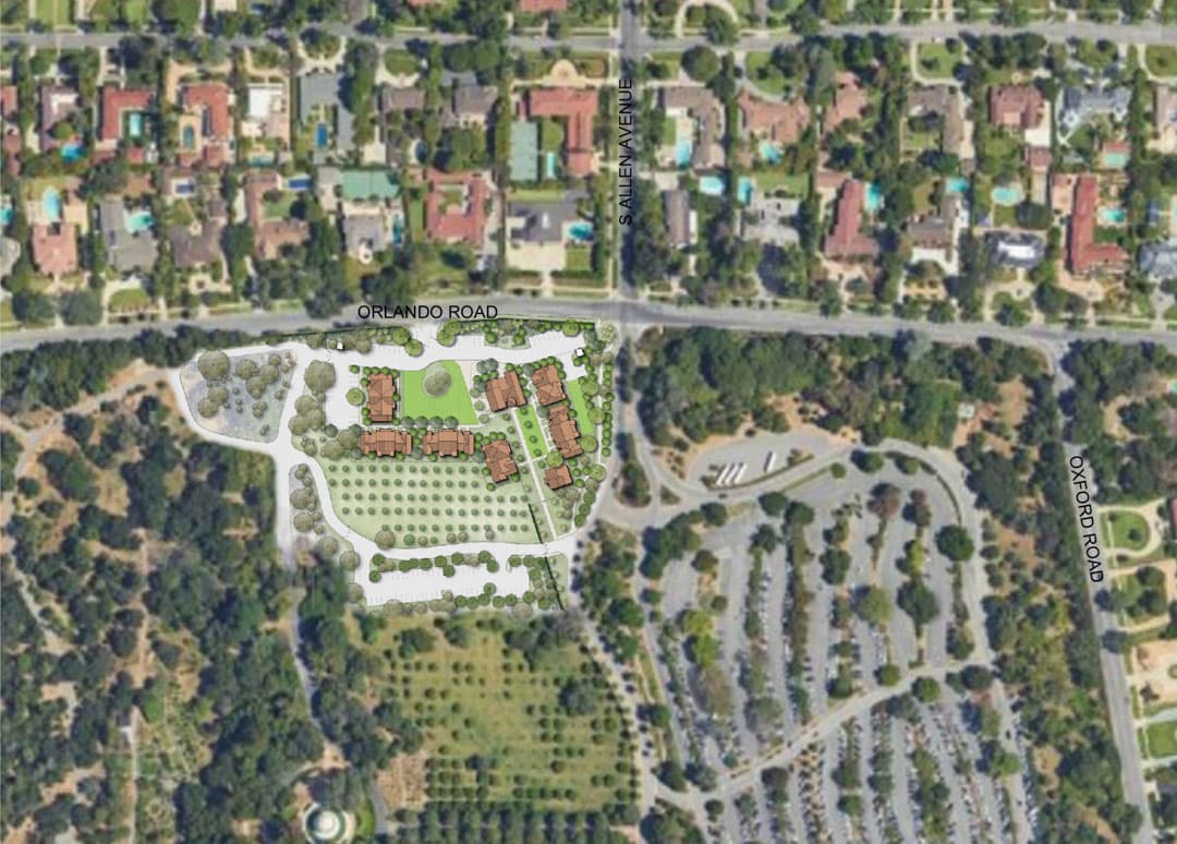 An aerial map of a neighborhood near a green space with a large parking lot.