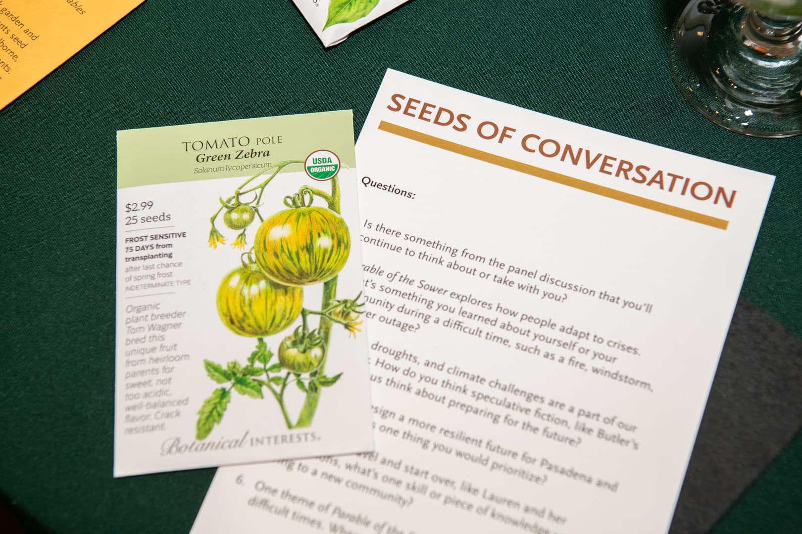 A packet of tomato seeds and sheet of typed text titled "Seeds of Conversation."