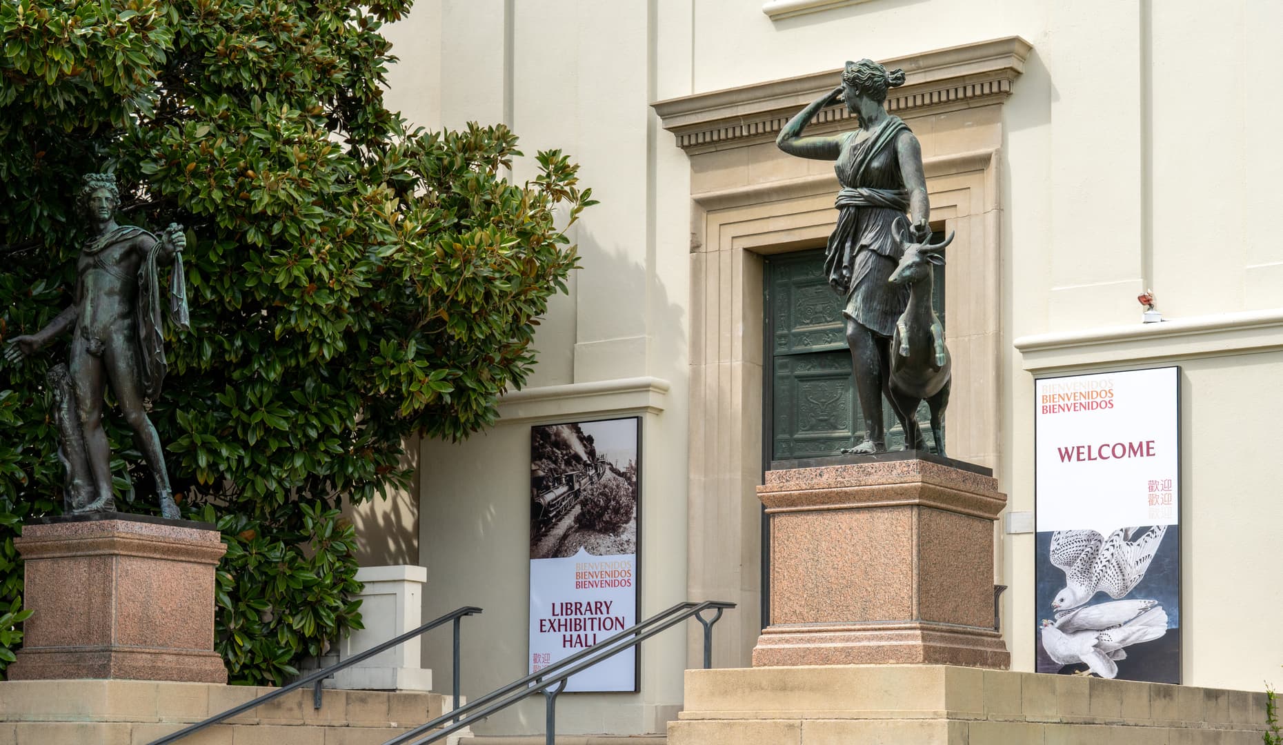 The doorway to a building, flanked by two statues.