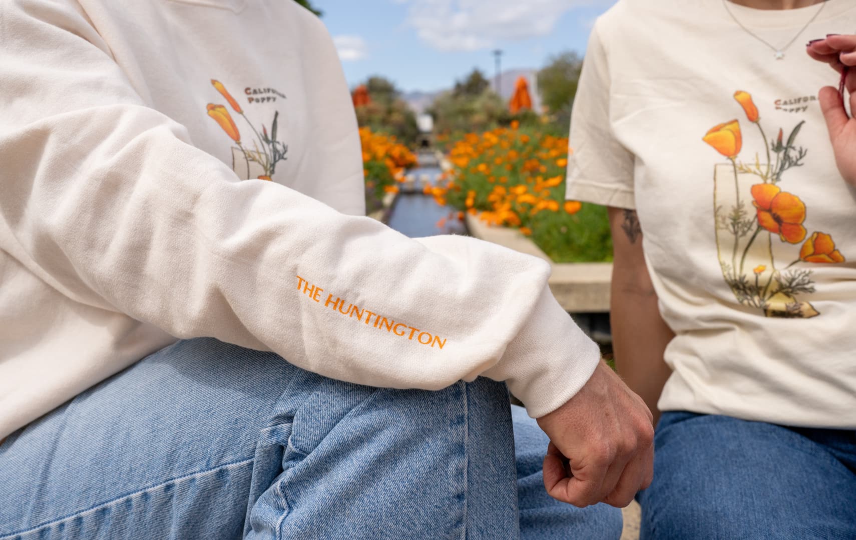 Two people wear light-colored tops featuring California Poppies.