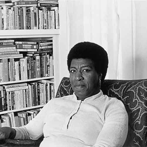 Patti Perret, photograph of Octavia E. Butler seated by her bookcase, 1984. © Patti Perret