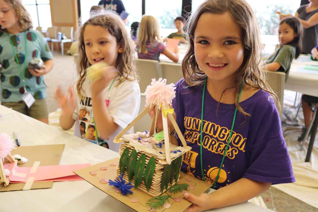 Camper showing her art project