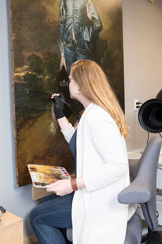 Conservator inpainting in the conservation lab