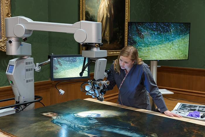 Christina O'Connell inspecting Blue Boy with microscope