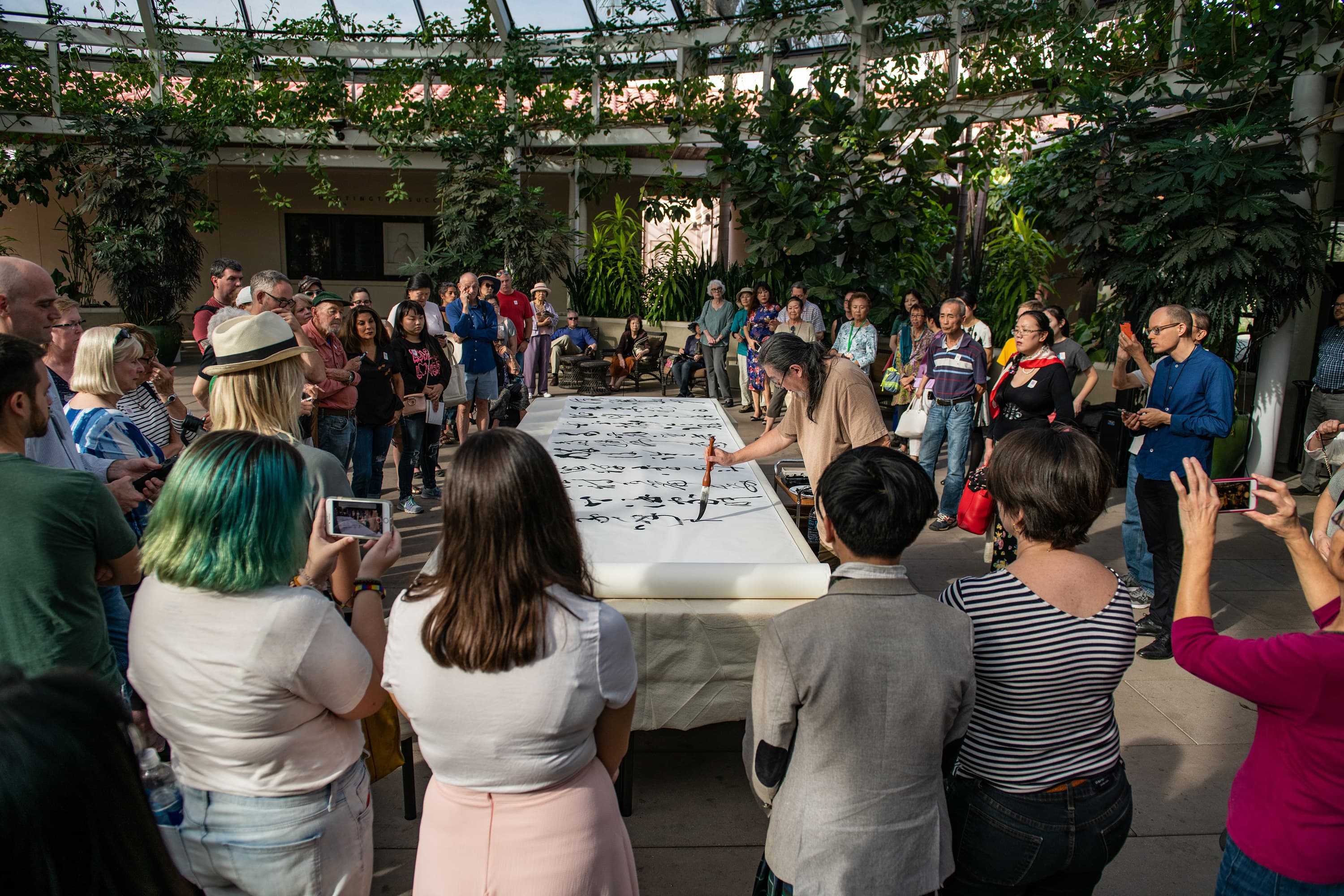 Tang Qingnian giving a demonstration of Chinese cursive calligraphy at The Huntington in November 2018, transcribing a 154-character Tang-dynasty poem, “Song of Eight Drinking Immortals.” Photo by Jamie Pham. The Huntington Library, Art Collections, and Botanical Gardens