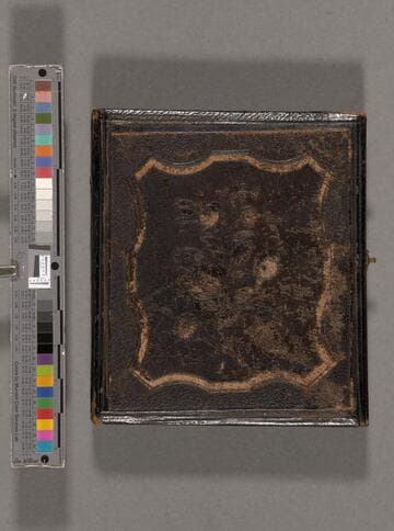 Portrait of unidentified young woman sitting at a table