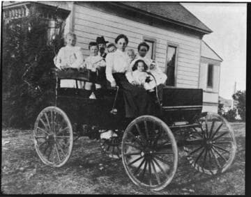 Mrs. Ensign and George W. Williams in the car built by George Williams and Orville H. Ensign