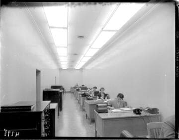 Long narrow room with one row of desks in Edison local office