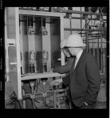 Engineers working and testing equipment at a substation