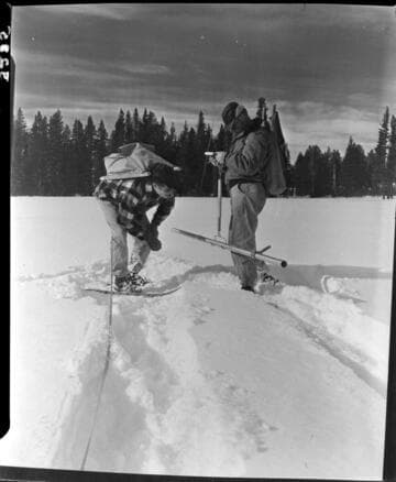 Big Creek snow survey. Close up of men reading depth and weight of snow in snow