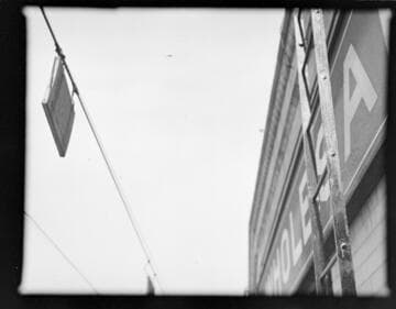 Power lines with warning signs close to building and fire escapes