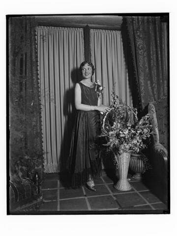 Woman with a corsage and flowers at the Club Casa del Mar, Santa Monica, California