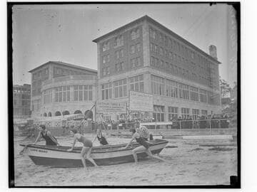 Swim team launching a lifeboat in front of Club Casa del Mar, Santa Monica, California