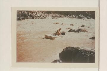One of the Nevills sadirons slipping free from the rocks at the end of the lining at Vulcan Rapid. Nevills perches on the deck