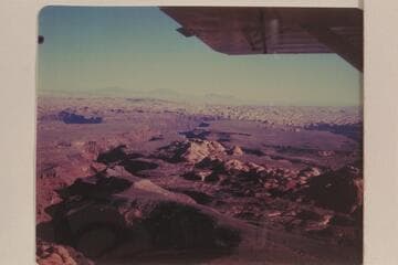 Looking down Cha Canyon from the air above the trail north of Navajo Begay- Cha flows into the San Juan River.  The Henry Mountains on the skyline, Waterpocket Fold is this side of the Henry's