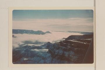 Up a clouded Grand Canyon from the South Rim below the Village.  Cape Royal, Wotans Throne, and Vishnu Temple at left center