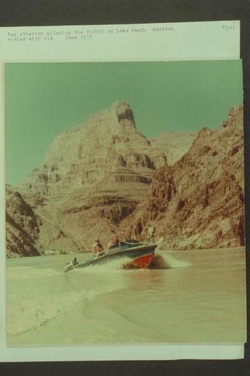 Pug Atherton piloting the "Bootoo" on Lake Mead. Marston riding with him