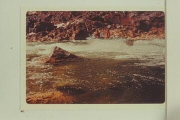 Buzz Belknap drives Mack Miller's Turbocraft up the top of Gneiss Canyon Rapid