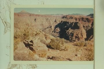 Cairn on Supai ledge on old horse trail which reached the river near Indian Creek. The Trumbull Mountains are on the skyline