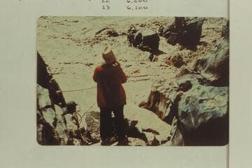 Upset at Mile 232.5.  Duane Bishop, Mrs. Gussie Schlosser and Bill Thompson on rock, Frank Wright and John Harper handle rope from shore at left and Pat McCormick in red on shore