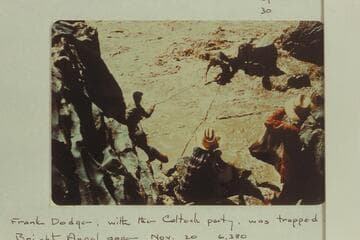 Upset at Mile 232.5. Duane Bishop leaping off rock, Frank Wright pulling and Lucy Arnold and Pat McCormick watching