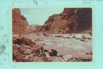Up River in Rapid No. 23. Buzz Belknap and Dock Marston work with the Sportyaks. The Sliced Boulder is center