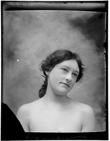 Head-shot portrait of a woman, with bare shoulders
