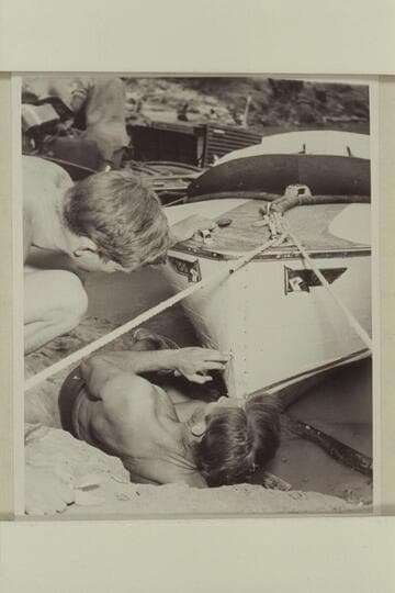 Daniels replacing the cutwater on the "Sweet Chariot" which had been ripped off when the craft hit the wall in Grapevine Rapid. Cooper watches the operation. Bright Angel Creek