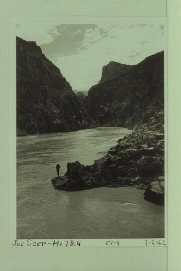 A smoothed Sockdologer Rapid.  Joe Szep on the rocky point at Mile 78.4