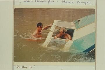 Inspection of the hull when half pulled from the river at head of Gneiss Canyon Rapid- John Harrington and Homer Morgan