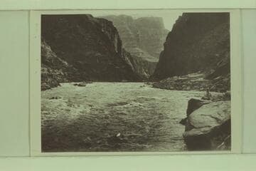 Identified by Emery Kolb as Lauzon on shore below Supai.  The extreme low water the Kolbs experienced in 1911-1912 gave them a difficult rocky course with relatively slow water
