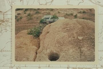 Holes in top of rock where Denis Julien cut his name and the date 1831. Near Whiterocks in the Uintah Basin
