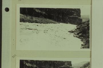 The "Esmeralda" making the first power run of Lava Falls. One of the photographers who climbed down from Tuweep watches the run from the right bank