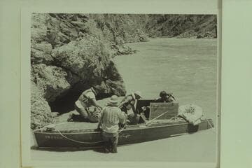 Hudson transferring his valuables to the Marston boat above the eddy where he had cut loose his "Esmeralda" on 1950, June 17.  Mile 99.4.  Left to right:  Edward Hudson; Ed Hudson; Marston; Forcier.  Bright Angel gauge:  54,000 cfs