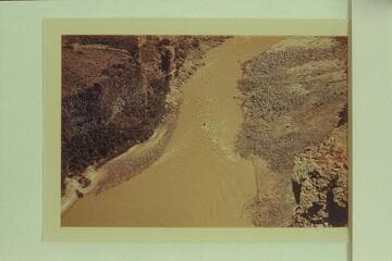 Whitmore Rapid, Mile 188; 16' Smith-Craft running down the jet.  Arizona Power Authority dam study