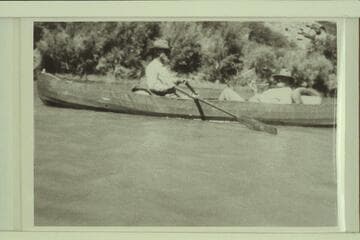 Dave Rust rowing one of his folding canvas boats in Glen Canyon in July, 1930. George C. Fraser sits in the stern. The journey was from Hite to Lees Ferry on the river