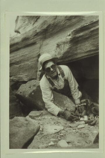 Bert Loper in Glen Canyon. Boatman for Dave Rust's party of July, 1930, running from Hite to Lees Ferry. A visit was made to the steps at El Vado