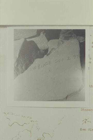 Reeves Baker sits over the "J. W. Black" name which is placed on a rock in a ruin to the left of the Aleson name. It is situated on the left bank of the Escalante, high in the alcoves of the wall; about 1/4 mile below 25 Mile Wash