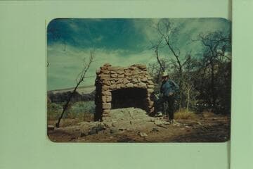 Old fireplace at Camp Stone. Ynez Haase stand near