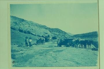 Supplies being hauled in for building the Hoskanini Dredge.  R. B. Stanton, Jr. and A. B. Starr (friend) in foreground