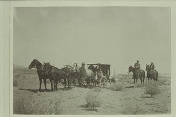 White-topped buggy owned by Charles Gibbons, Hanksville, Utah, and used for meeting guests in Green River. Left to right: Cunningham; Rufus Stoddard; Weisholn; Charles Gibbons on "Old Betsey," George Gould
