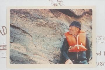 Dock Marston posed at the 1836 D Julien inscription in Cataract Canyon at Mile 185.75. Later Visitors belieVed they deciphered an inscription to the right reading D/GCMICo/1891